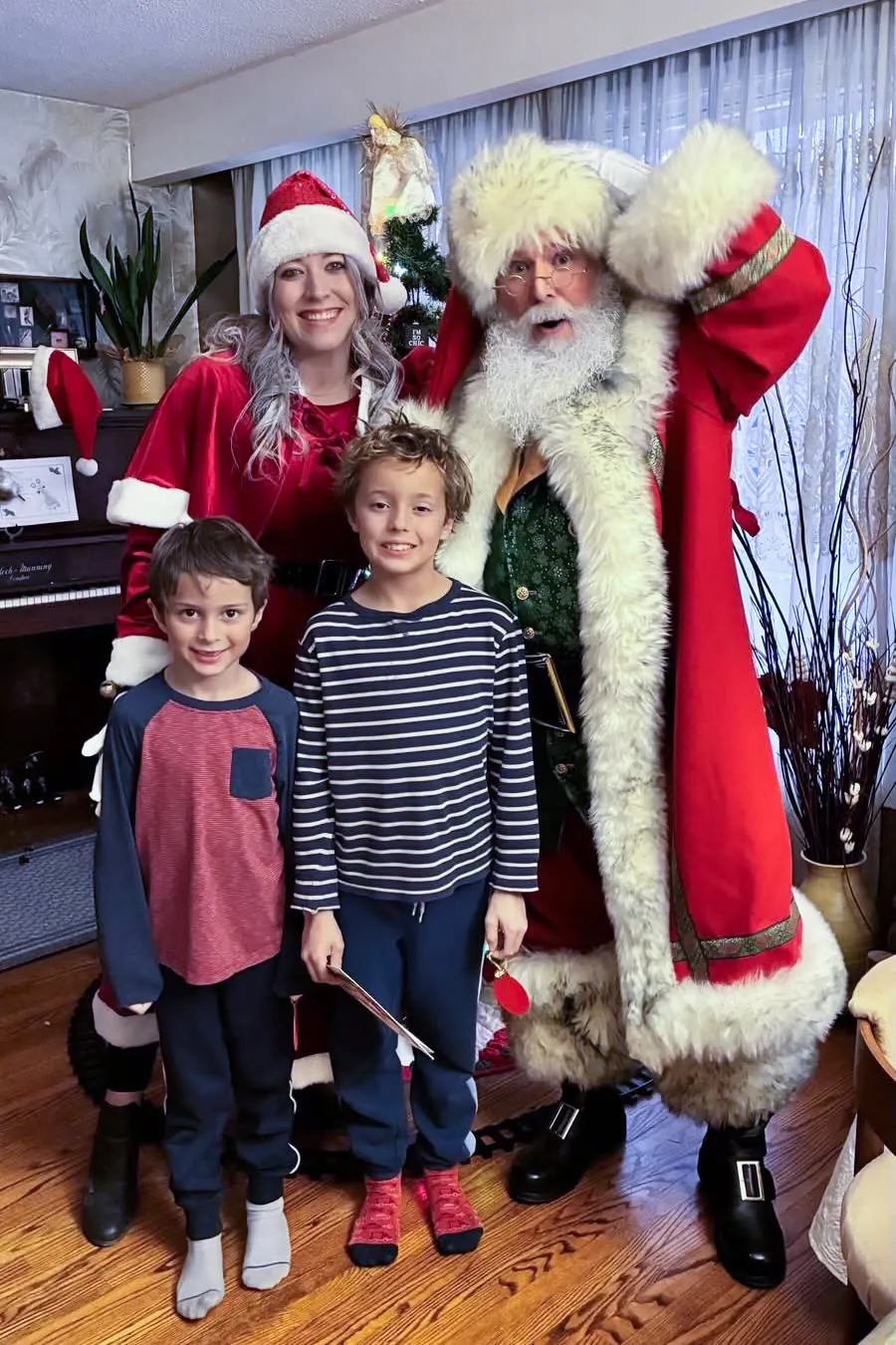 Santa Stu with a family during a Christmas home visit